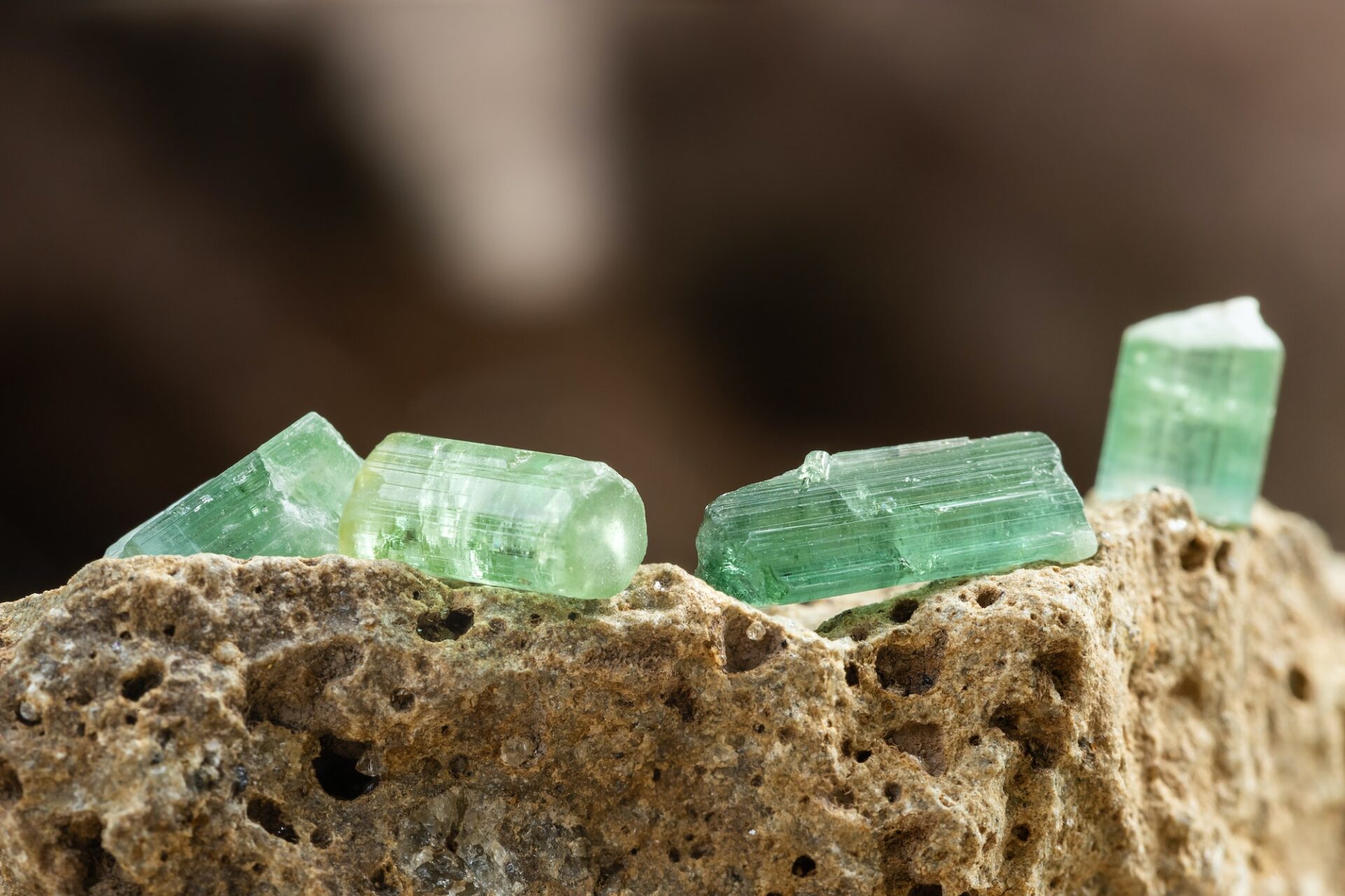 Set of Tourmaline Crystals on Rough Stone Background